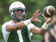 Evergreen receiver  Justice Murphy participates in spring football practice on Tuesday at McKenzie Stadium.