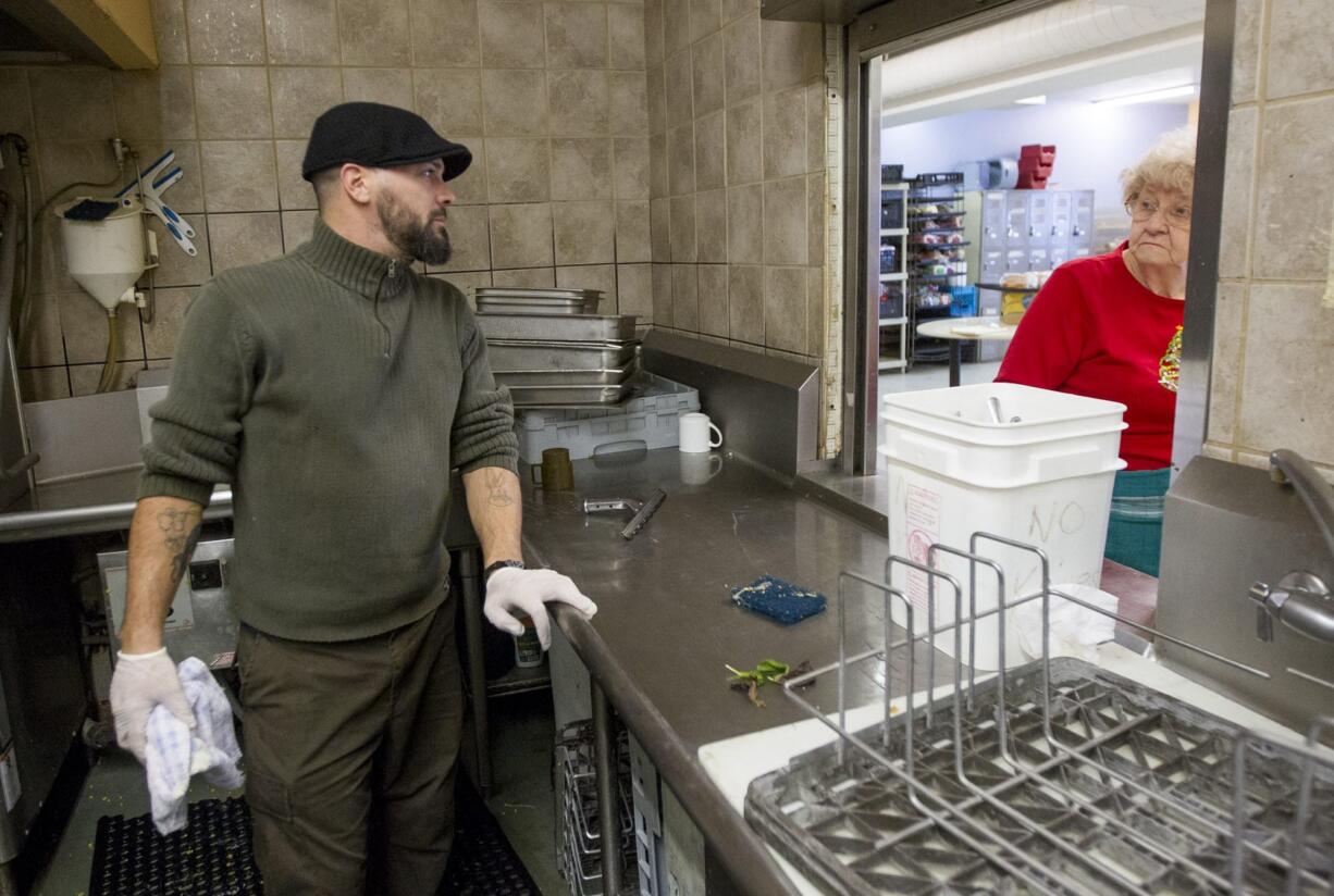 David Willis, part of the kitchen crew at Share House, cleans up after lunch on Friday.