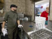 David Willis, part of the kitchen crew at Share House, cleans up after lunch on Friday.