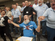 Bart Moore sings during a rehearsal with the Vancouver USA Singers on Monday. The choir is holding a benefit concert for Val and Bart Moore's after their mobile home burned down on the Fourth of July.