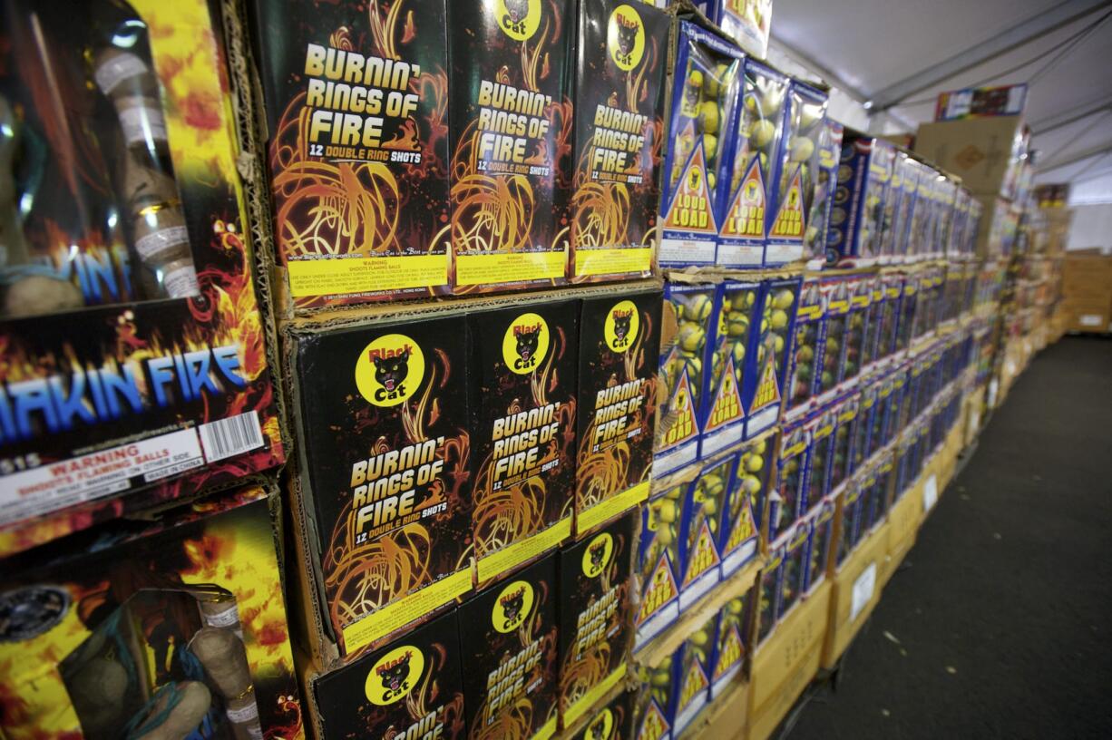 Workers set up the Bomber Brothers firework tent at 78th Street and Hwy. 99, Tuesday, June 24, 2014.