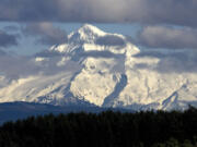 Clouds flit across the west face of Mount Hood as seen near Boring, Ore., in February 2010.