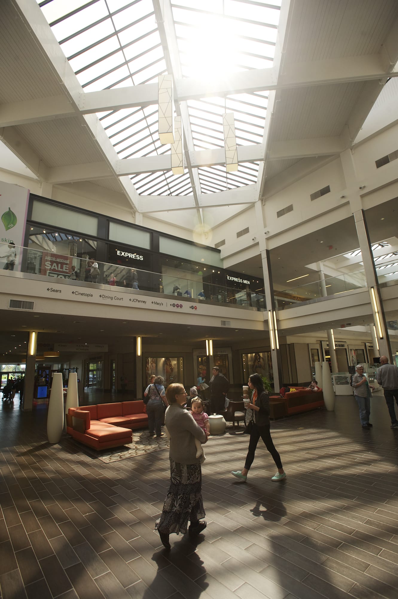 Afternoon shoppers stroll the promenade at Westfield Vancouver mall, which will soon add four tenants as another moves to a larger space.