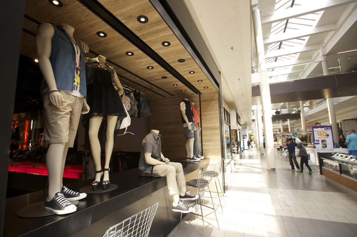 Afternoon shoppers stroll the promenade at Westfield Vancouver mall, which will soon add four tenants as another moves to a larger space.