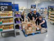 Walmart cashiers Amanda Wiser, from left, Kassy Gee, Lanaya Jerabek and Haley Black sort through merchandise while preparing for the Sept. 23 opening of Wal-Mart's seventh Clark County store.