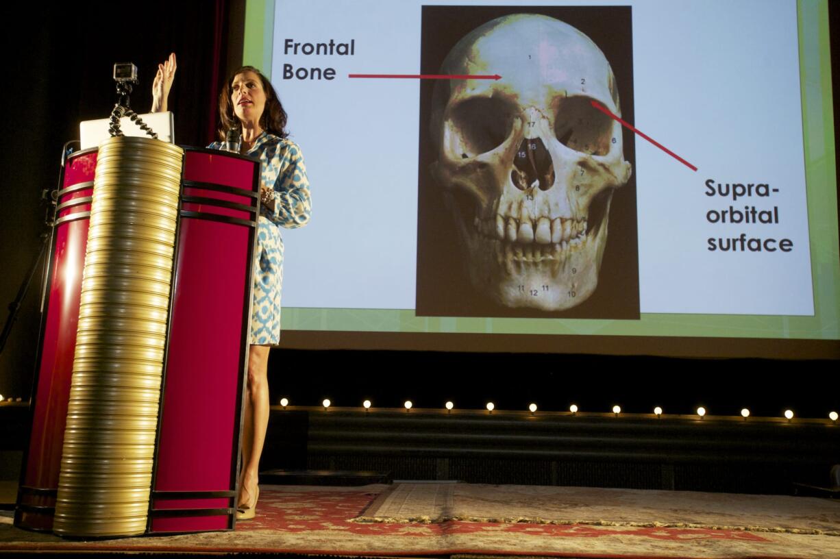 Nici Vance, Oregon's forensic anthropologist, talks at the Kiggins Theatre on  Wednesday evening about how she examines bones to help identify crime victims.