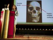 Nici Vance, Oregon's forensic anthropologist, talks at the Kiggins Theatre on  Wednesday evening about how she examines bones to help identify crime victims.