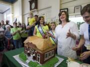 Outgoing Clark County Historical Museum Executive Director Susan Tissot cuts a cake created in the likeness of the museum to celebrate the 50th anniversary of its dedication.