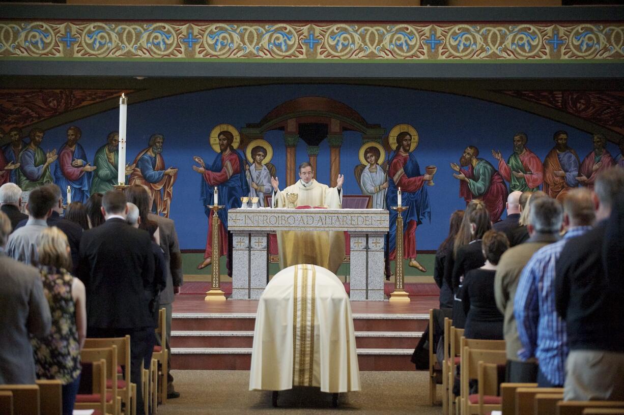 The Rev. Gary Lazzeroni of St. Joseph Catholic Church celebrates a memorial Mass on Tuesday for Vancouver police Sgt.