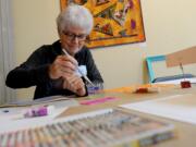 Judi Bremes gets colorful during Art Break Day in the Vancouver Marketplace courtyard.