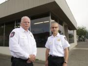 Camas-Washougal Fire Chief Nick Swinhart, right, and Fire Marshal Ron Schumacher pause on a busy moving day outside of the department's new fire marshal's office at Northeast Everett Street and Third Avenue.