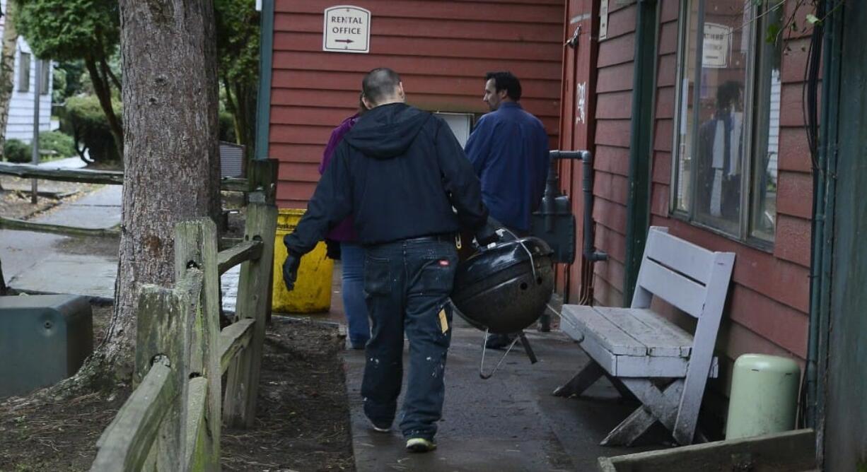 Courtyard Village Apartments residents on Dec. 10 started cleaning up the grounds and removing everything that had been left outside, including personal possessions such as a barbecue grill, after residents were given notice to vacate. The Vancouver City Council unanimously approved three ordinances Monday night designed to protect vulnerable, low-income renters. The ordinances will give renters more time to find new housing when told to vacate or told that rent is increasing, and would prevent landlords from refusing to rent to people based on their source of income.