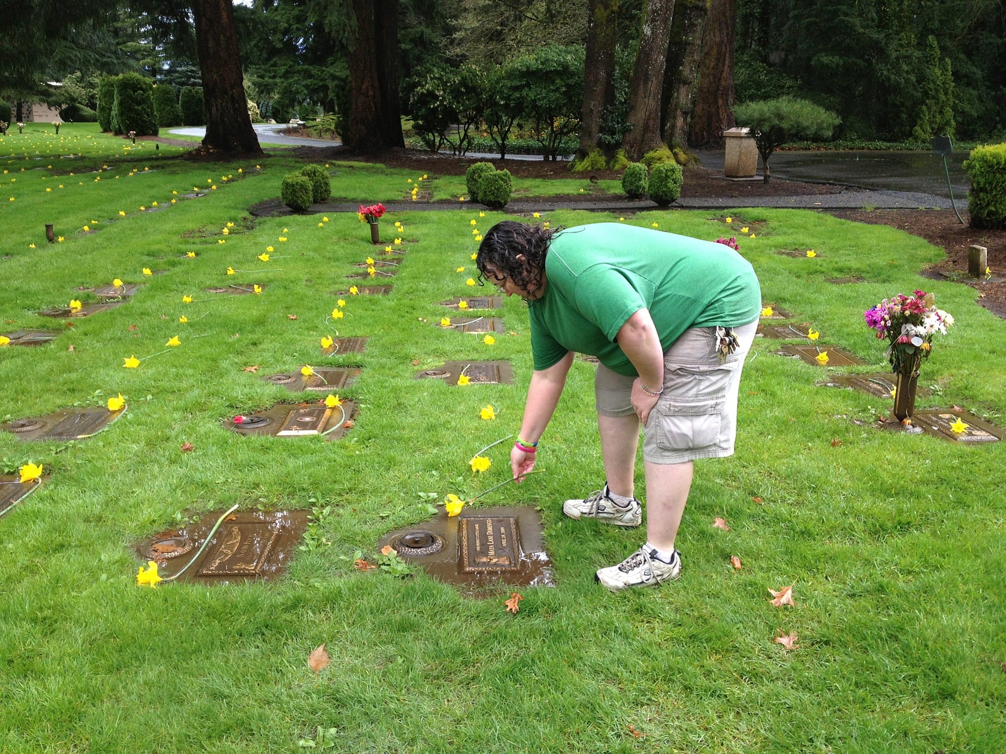 Courtesy of Teresa Wentworth
Teresa Wentworth places a flower at a grave site at the Evergreen Memorial Gardens Cemetery in Vancouver. She and a group of family and friends bring flowers each year and place them at as many graves as possible.