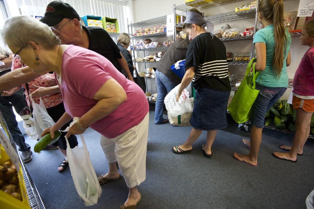 By code, 10 people at one time are all that's allowed inside the shopping area at the North County Community Food Bank in Battle Ground.