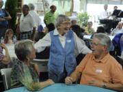 Betty Eves, center, chats with Gayle, left, and Mike Mattson as Friends of the Carpenter celebrates the 10th anniversary of its Friendship Center and thanks its many volunteers.