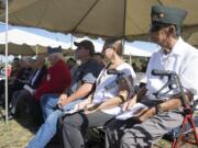 Robert H. Navarette, right, a World War II veteran, listens to speakers at the POW/MIA Recognition Day Observance at the Armed Forces Reserve Center in Vancouver on Saturday, Sept. 19, 2015.