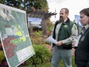 Tedd Huffman, monument manager at the Mount St. Helens National Volcanic Monument, left, and Angie Elam of the Gifford Pinchot National Forest, look over a diagram of the Mount St. Helens Forest Conservation Area on Tuesday morning, Sept. 22, 2015 at the Lynch Residence in Vancouver.