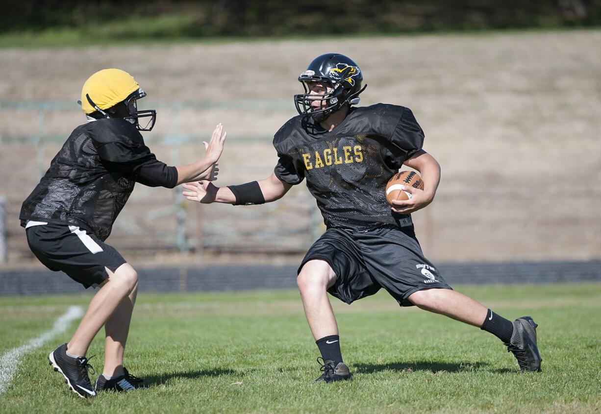 Hudson's Bay's Stone Sabourin, right, finds room to run during practice Thursday afternoon, Sept. 10, 2015, at the team's practice field.