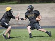 Hudson's Bay's Stone Sabourin, right, finds room to run during practice Thursday afternoon, Sept. 10, 2015, at the team's practice field.