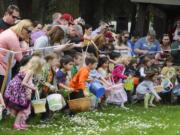 Children race onto the field as an Easter egg hunt begins Sunday at Crown Park in Camas.