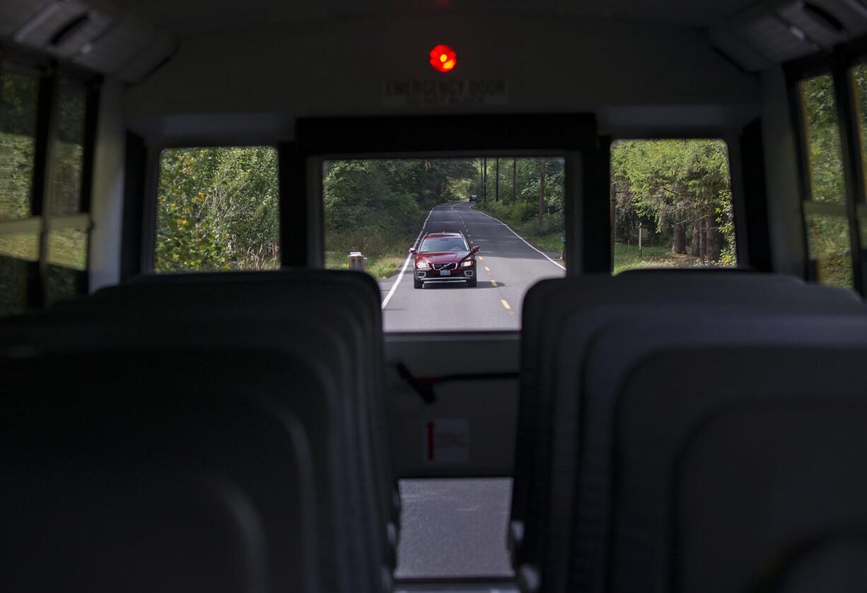 A driver follows school bus driver Ron Condon as he drives through Battle Ground School District on Tuesday morning. , Sept. 1, 2015.