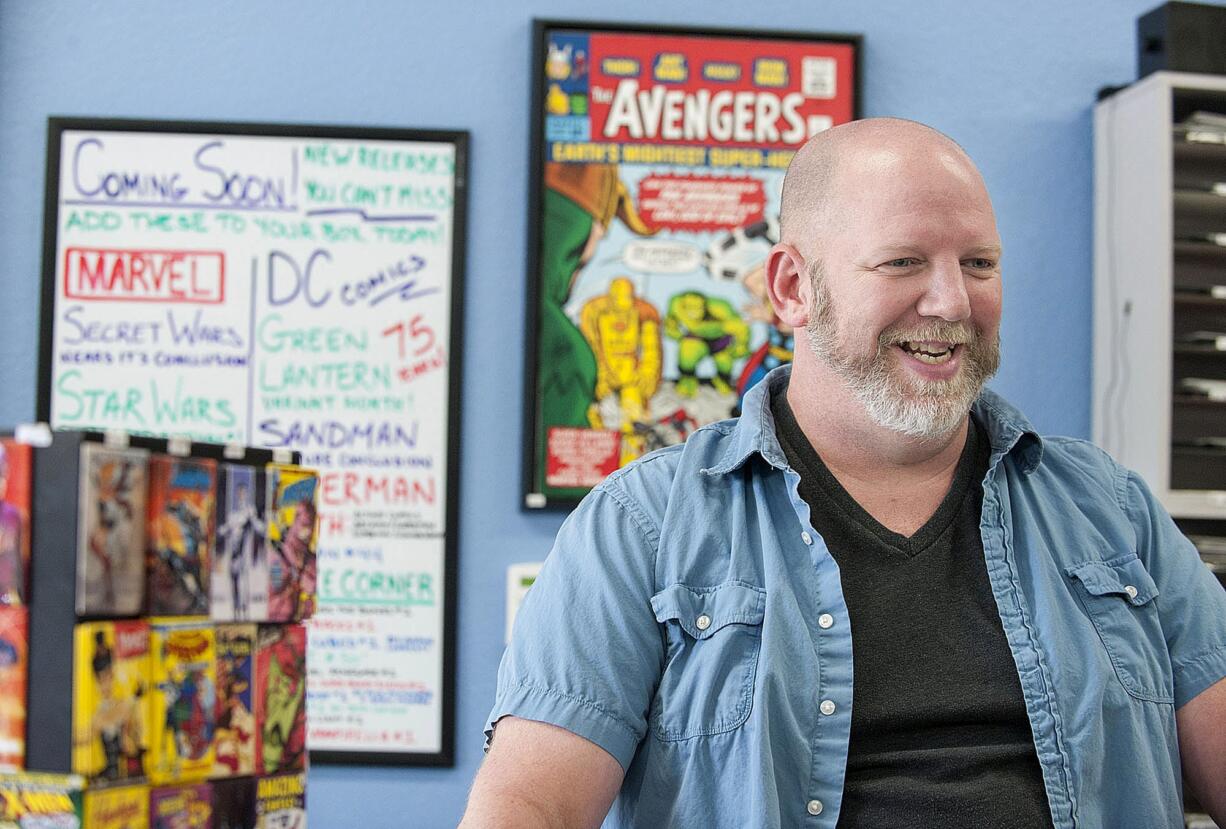 Chris Simons, owner of I Like Comics, shares a laugh with a customer at his Vancouver comic book shop Thursday afternoon, August 27, 2015.