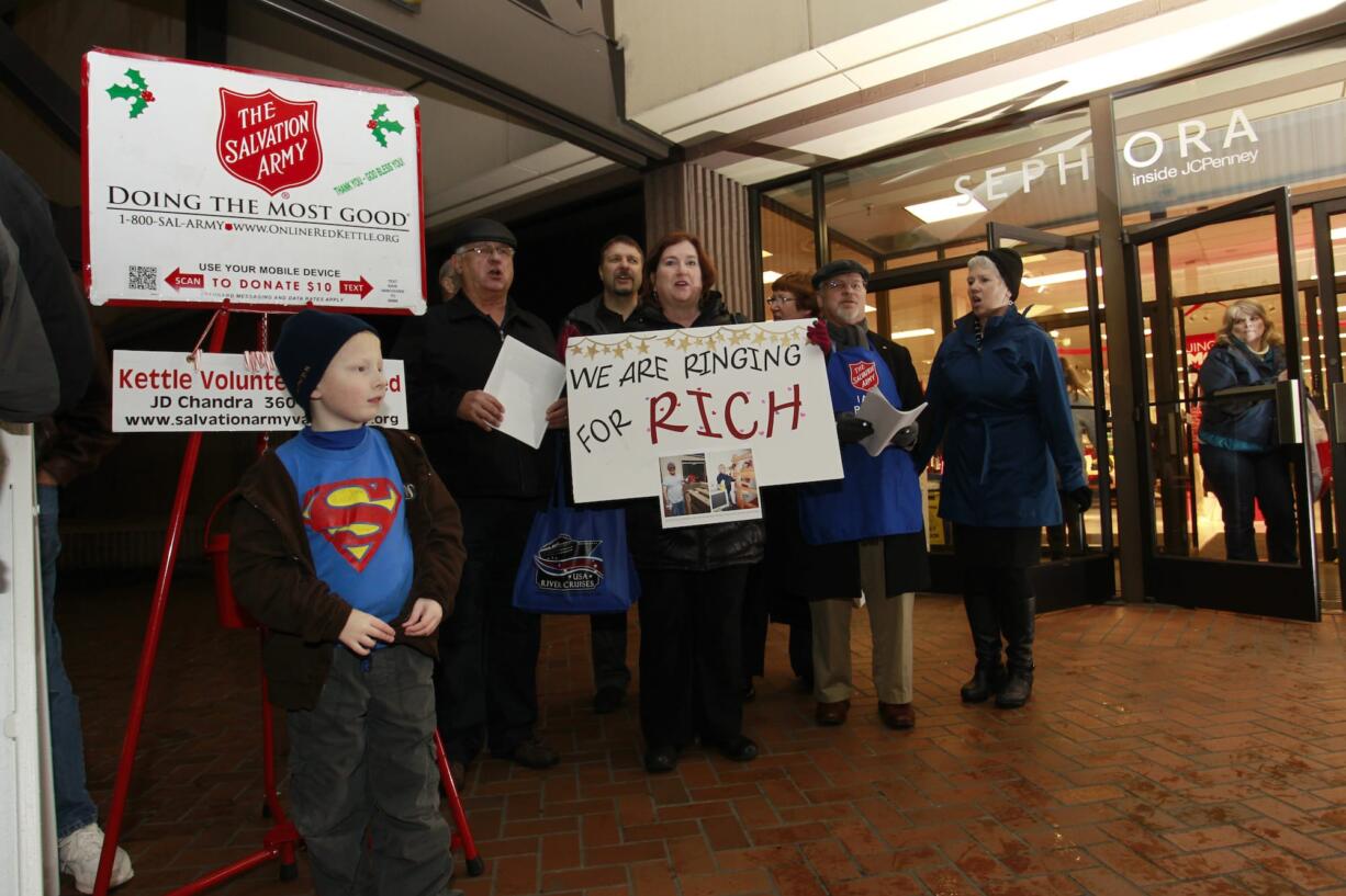 Steve Dipaola for the Columbian
Rotary club members pose for a photo while ringing Salvation Army bells Wednesday evening at J.C. Penney. Member Rich Irvine was scheduled to work the slot, but has been in the hospital since Dec. 7 after getting struck by a minivan on Interstate 205.