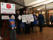 Steve Dipaola for the Columbian
Rotary club members pose for a photo while ringing Salvation Army bells Wednesday evening at J.C. Penney. Member Rich Irvine was scheduled to work the slot, but has been in the hospital since Dec. 7 after getting struck by a minivan on Interstate 205.