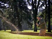 Kent Myers hits out of the sand trap on the 15th hole at Royal Oaks Country Club on Friday June 6, 2014.