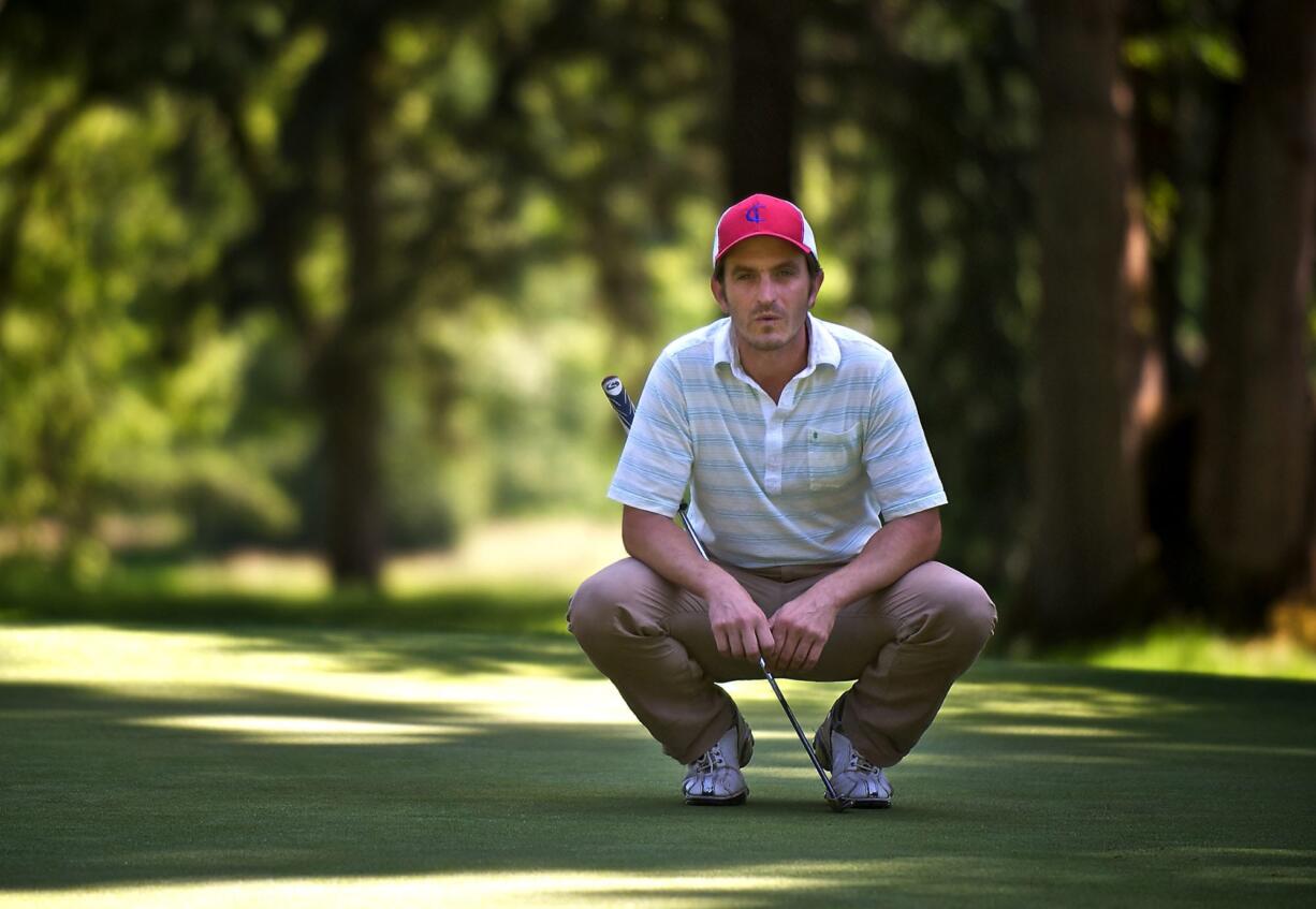 Dan McLaughlin sizes up his putt on the 15th hole at Royal Oaks Country Club on Friday.