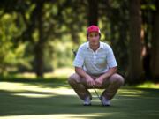 Dan McLaughlin sizes up his putt on the 15th hole at Royal Oaks Country Club on Friday.