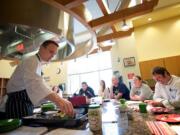 Garrett Berdan, a chef and registered dietitian from Bend, Ore., demonstrates techniques for enhancing the flavors of spices and using more flavorful ingredients during a class for local chefs Wednesday.