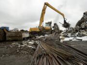 Scrap metal is loaded onto a conveyor and into a shredder at Pacific Coast Shredding in 2011.