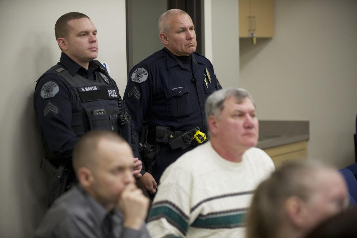 Cpl. Neil Martin, left, and Cpl. Jim Burgara attend a meeting of the Vancouver neighborhood alliance at the VPD East Precinct.