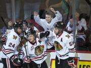 Winterhawks Brendan Leipsic, center, celebrates his first goal of the evening against the Vancouver Giants in the first period of game one of their best of seven series at the Moda Center on Friday March 21, 2014.