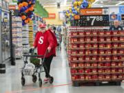 Wal-Mart employee Helen Crank greets shoppers dressed as an oversize Skittle while handing out free samples of the candy on Wednesday morning at the new Wal-Mart in Orchards.