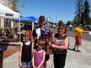 Northeast Hazel Dell: Mike and Kelly Sparano hold a Best in Show trophy, which they won during the 28th-annual Mustang Stampede Car Show on July 26 at the First Church of God in Vancouver.