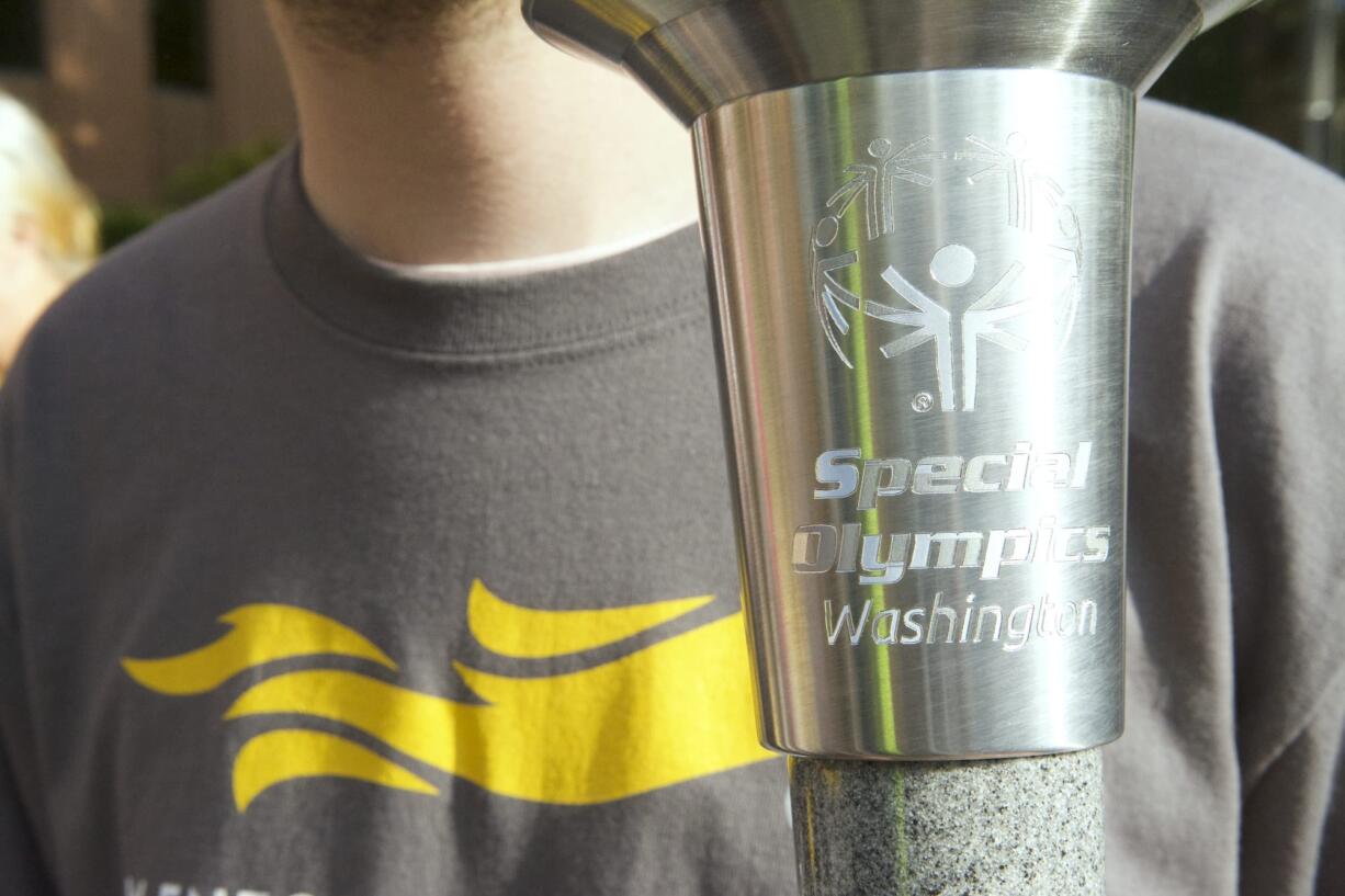 Andrew Stekhuizen holds the Special Olympics torch outside the Clark County Courthouse on Wednesday.