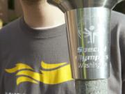 Andrew Stekhuizen holds the Special Olympics torch outside the Clark County Courthouse on Wednesday.