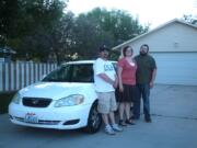 Randy Misner, from left, Leslie Holmes and Rob Holmes of Price, Utah, stand next to Rowan Coash's car.