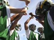 Evergreen's Rey Green, center, huddles with teammates during practice at McKenzie Stadium on Thursday.