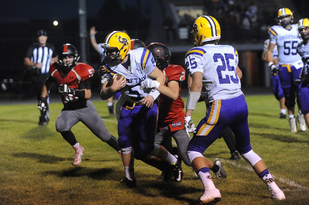 Columbia River quarterback Garrett McKee scores a touchdown against R.A. Long  in Longview.