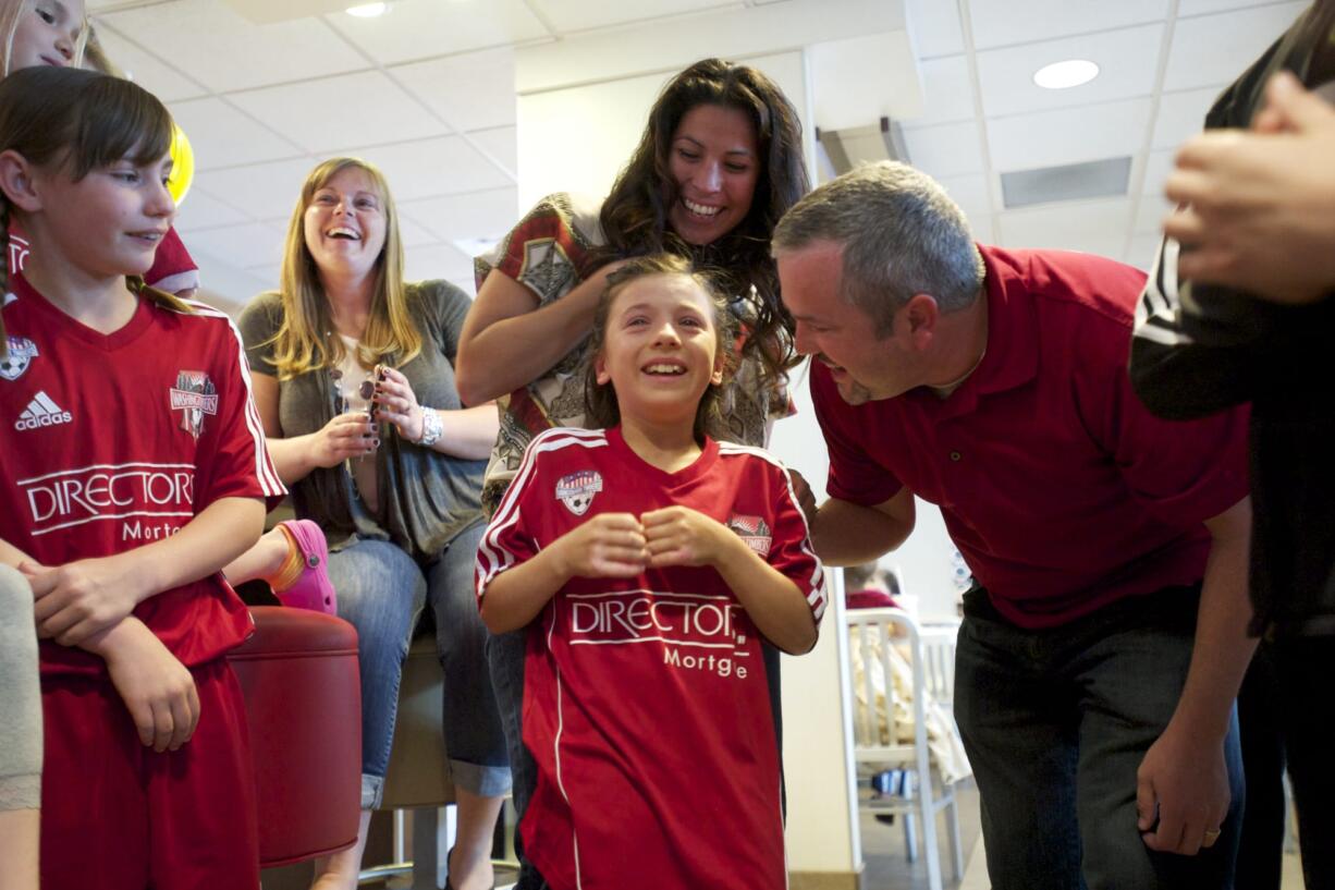 Mallory Stonier gets the good news while she's at the McDonald's on Mill Plain with her mom Monica Stonier, dad Brandon Stonier and her east Vancouver soccer team.