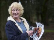 Cindy Koch, of Vashon Island, joins a group of volunteers Wednesday at the Gee Creek rest stop as they post fliers seeking Daisy, a terrier that went missing after a 28-vehicle crash on Interstate 5 earlier this month.