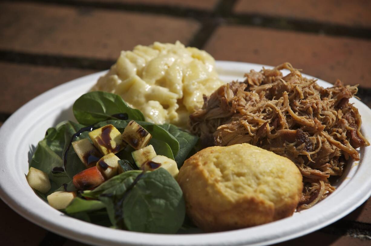 Esoteric BBQ serves up barbecue chicken with cheese shells, corn bread and salad at its downtown Vancouver food cart on June 6.