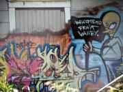 Graffiti on a longtime problem house on Fruit Valley Road was the subject of an order by the city of Vancouver, requiring owner Paul Johnston to bring the building up to code or it will be demolished.
