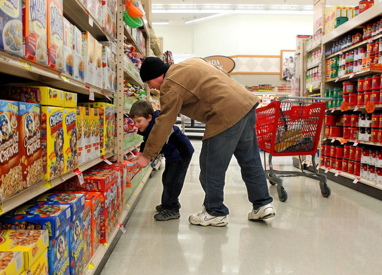 Joe Pyatt and his son, Caleb, 5, shop in Kirkwood, Mo., in December 2012.