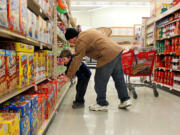 Joe Pyatt and his son, Caleb, 5, shop in Kirkwood, Mo., in December 2012.