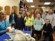 The Country Critters 4-H Rabbit Club learn all things rabbit from veterinarian Alayson Phelps, left, during a 2013 tour of VCA East Mill Plain Animal Hospital.