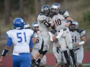 Union High School's Keithen Shepard, center, celebrates with teammates including Jordan Lawson (10) after scoring a touchdown in the first quarter Friday at McKenzie Stadium.(Amanda Cowan/The Columbian)